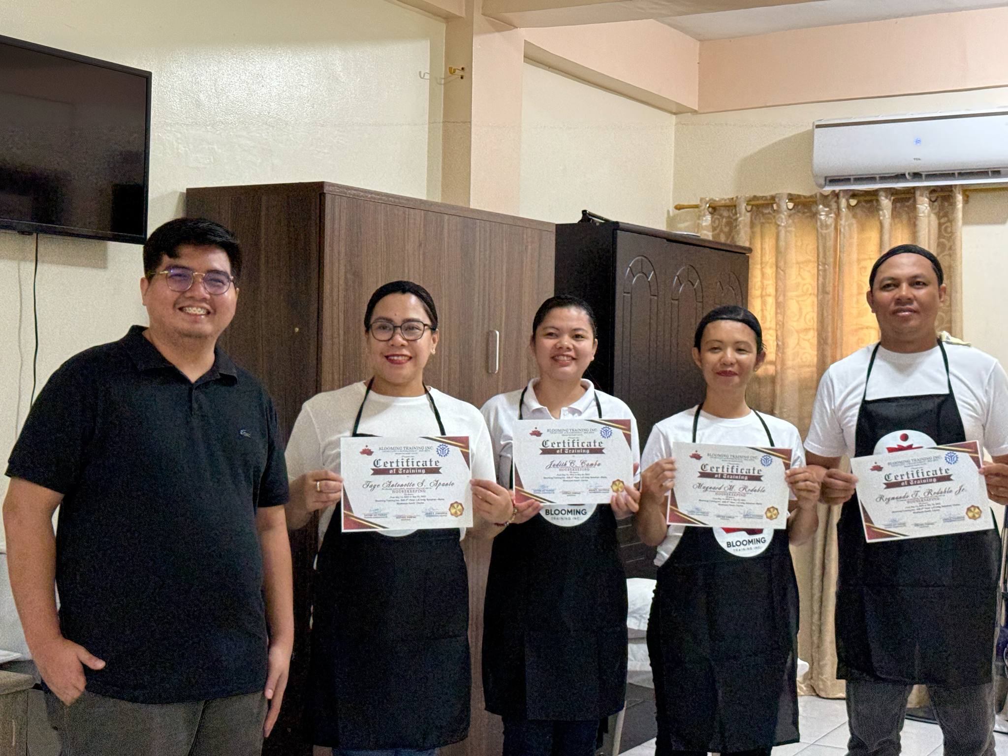 Instructors teaching hotel housekeeping procedures