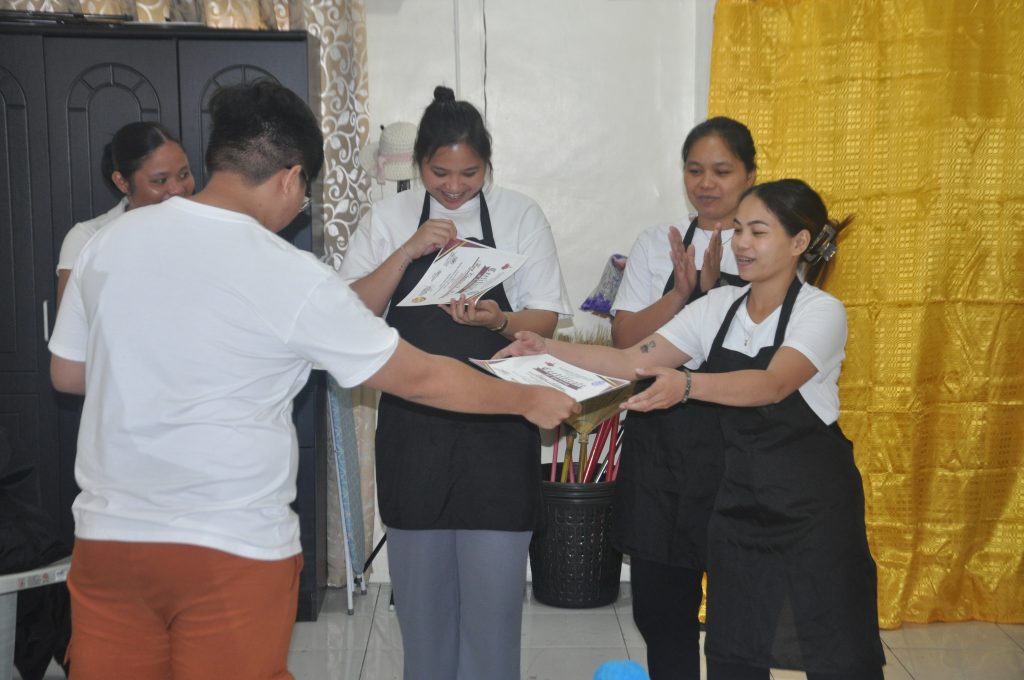 TESDA scholarship students in professional hotel uniforms